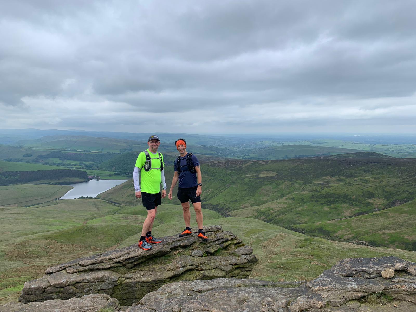 Two people on a mountain summit